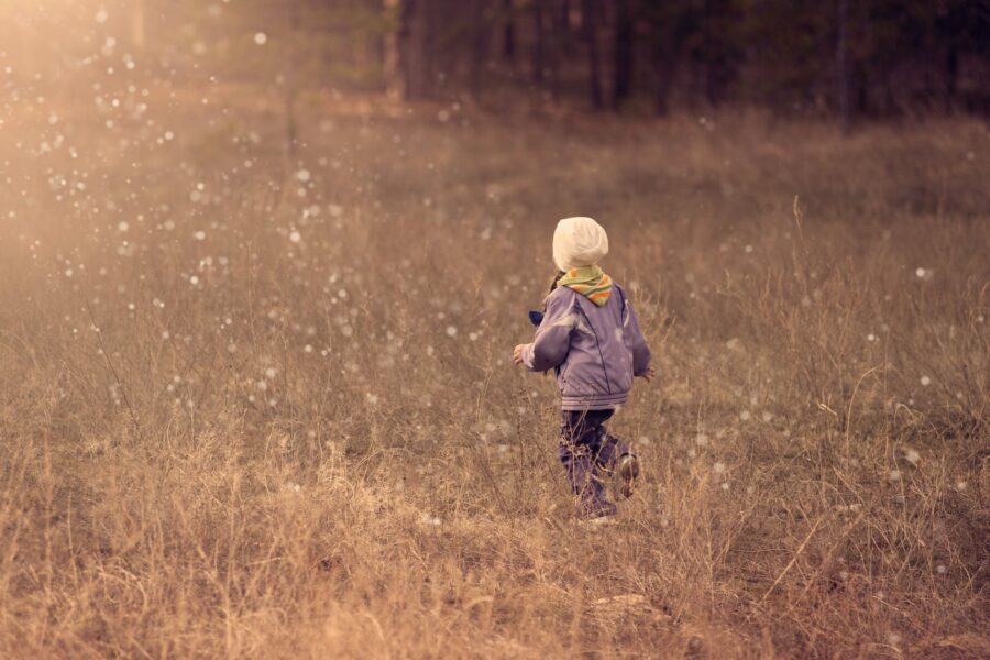 child walking on grass path