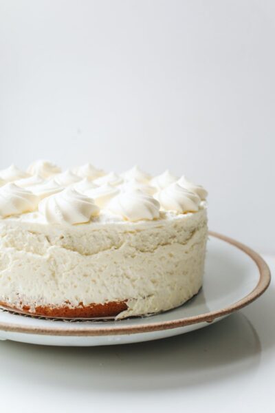 photo of white cake on ceramic plate